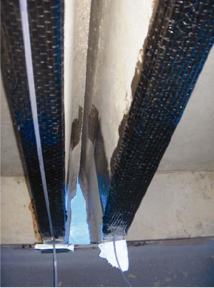 Figure 4.11. Photograph of ribbon placement during installation of FRP reinforcement on lower surfaces on bridge girder.