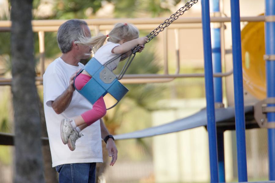 When someone pulls back on the chains of a playground swing, as shown in the picture above, the swing moves higher.