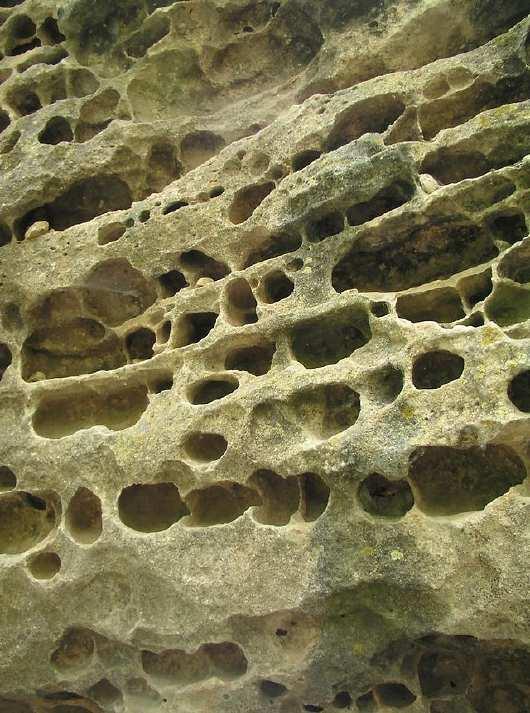 Chemical reactions caused by heat and water break down the bonds holding the rocks together, causing them to fall apart, forming smaller and smaller pieces.