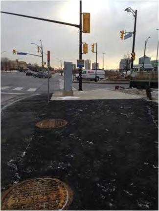 pedestrian crossings; pedestrian signals and push buttons at all corners. Asphalt repair partially obscuring markings on south leg of intersection.