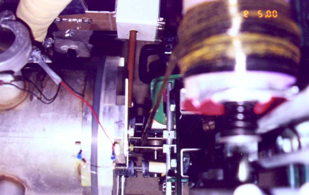 Figure 5. Carbon/polyimide tape being transported through electron beam and consolidation rollers. Figure 6. E-beam processed polyimide tape.
