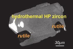 Discrete zircon rims or domains are common features of zircon in subducted rocks. These rims form on inherited magmatic (FIG. 1E) or detrital cores (FIG.