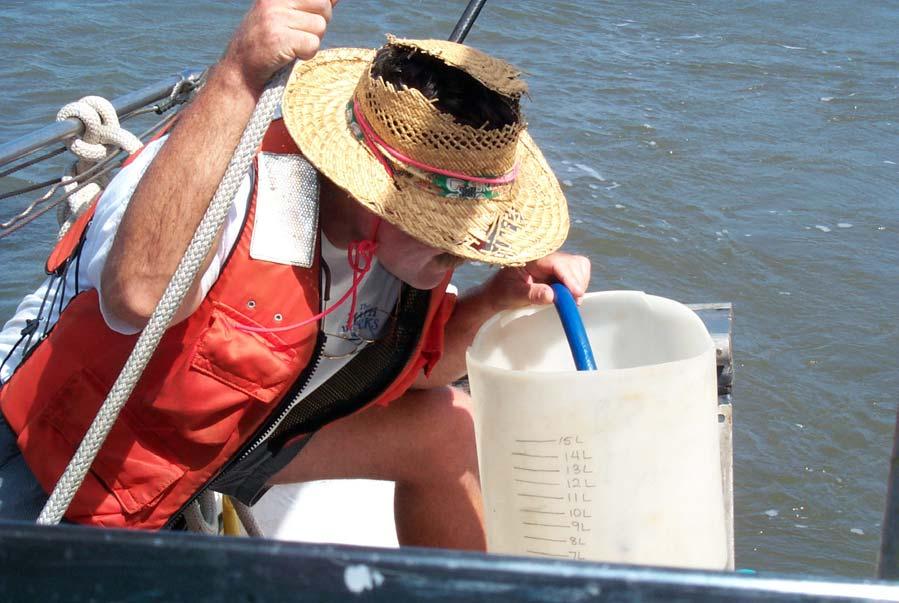 Figure 3. Collection of at least 10 liters of water pumped from depth in churn splitter during July 2001 field survey.