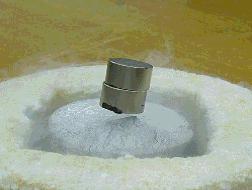 FIG. 11: Rigid levitation of a NdFeB sintered columnar magnet above a superconductor. FIG.