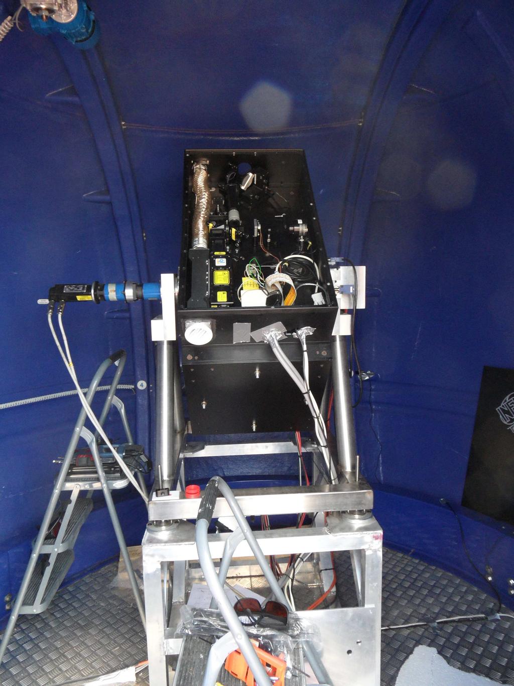 Figure 4: The ARCADE Lidar system. The black box includes the laser bench, primay mirror and receiver. The steering mechanism is visible. The system is located inside the astronomical dome.