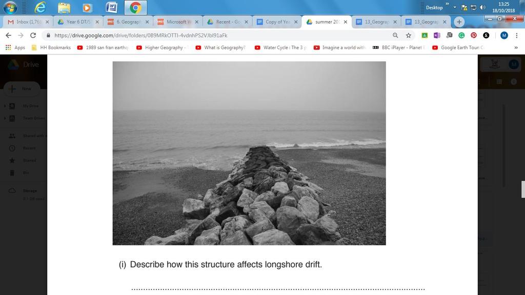 (d) Study the photograph below which shows a rock groyne at Hastings, East Sussex.