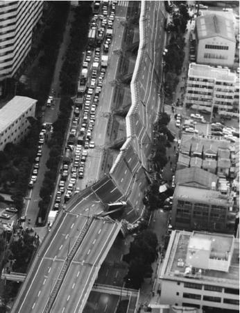 A portion of the Hanshin Expressway is twisted down on its side in Nishinomiya after a powerful