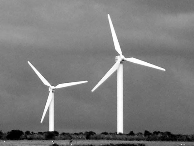 3 22 10 Fig. 10.1 shows part of an array of wind turbines on farmland. Fig. 10.1 (a) Each turbine converts the kinetic energy of the wind into electrical energy. 1.16 10 7 kg of air, travelling at a speed of 20 m s 1, pass through the turbine each minute.