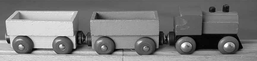 4 Wooden trucks on a toy railway have permanent magnets that hold the train together. The magnets are arranged so that an N-pole touches an S-pole between each truck, as shown in Figure 10.