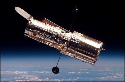 The Hubble Space Telescope is floating in outer space