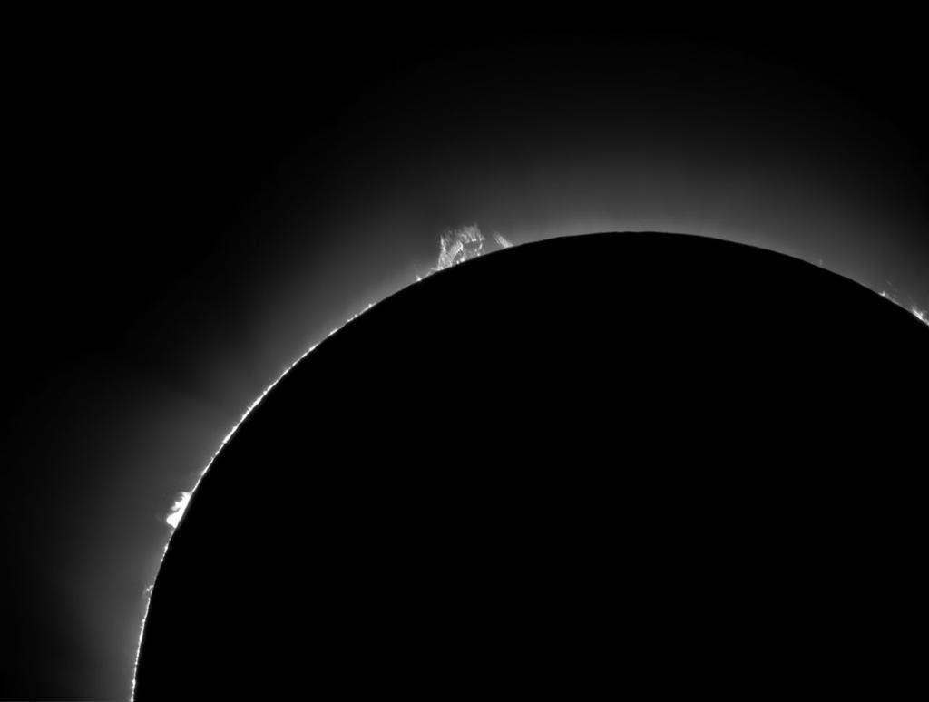 A shorter exposure at higher magnification reveals other details: * The inner corona glows around the entire disk of the Moon. * Several large prominences extend far beyond the disk of the Moon.