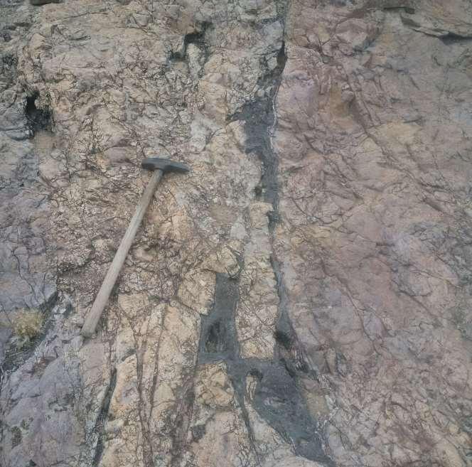 Geology of Overlying Rhyolite Black calcite plus quartz veins in