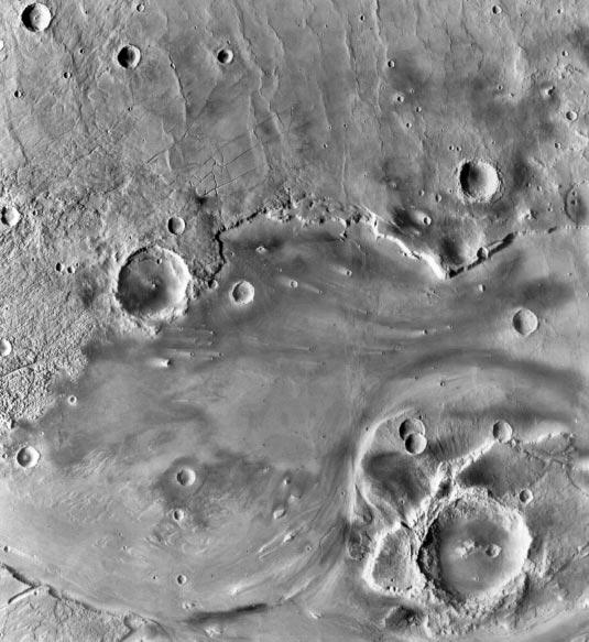 100 km Scale: The crater in the lower right is about 100 km across. Image 8 Which came first, the fractures or the large crater left of center?