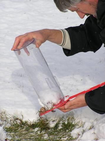 - Slide a thin, flat object under the core sample and the gauge - Carefully lift and flip the gauge. - Now you can melt the snow the same as you normally would.