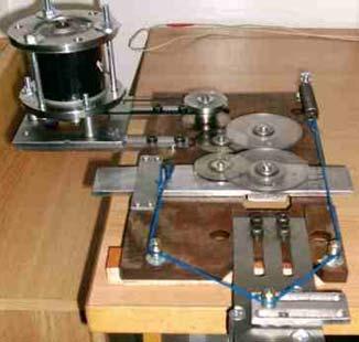 The experimental testing device is presented in Figure 11, made based on the kinematical scheme from Figure 10. The driving motion is made using a d.c. motor and a belt transmission. Figure 11. Detail and general view of the experimental device.