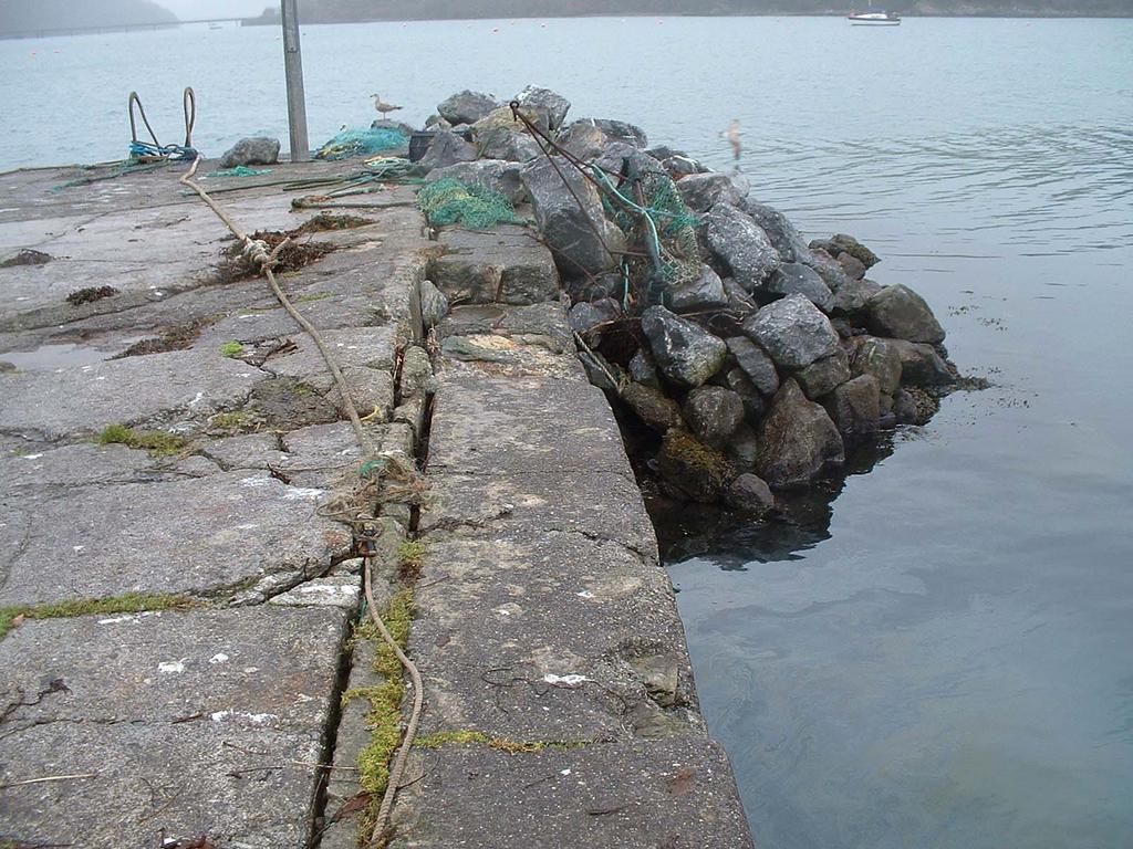 The stone jetty is in the village again built on a rock outcrop with deep water on the quayside and end.