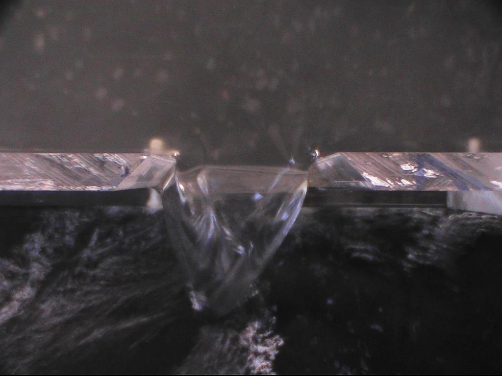 Experimental Flume ROWLINGS (2010) Figure 4-4 Weir flow clinging to outer channel face 4.2.3 Stilling the Flow To prevent this disturbance to the flow more intensive stilling measures were put in place.