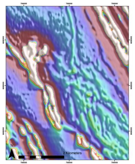 This lithostructural interpretation, when combined with the gold-in-soil results and bed rock gold anomalism, was used for identifying prospects within the T6 camp scale target for fenceline drill