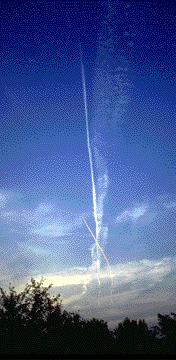 Contrails form high in the atmosphere when the mixture of water vapor in the aircraft exhaust and the air condenses and freezes.