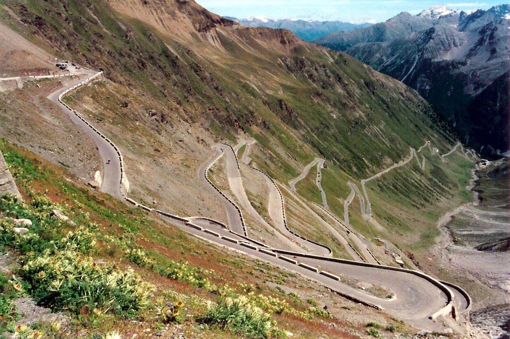 Image credit: Wikipedia. (Northern end of Stelvio Pass, Italy) From warmup: Switchbacks on mountain roads (consider only work done against gravity): a.