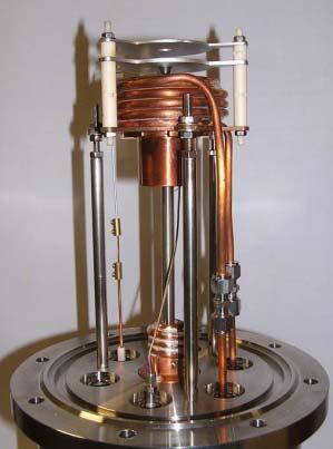 into the plasma chamber at 90 one from each other. The soft iron magnetic plug at the injection has two grooves (Fig. 8) to allow the passage of the two WR62 waveguides with water cooling tubes.