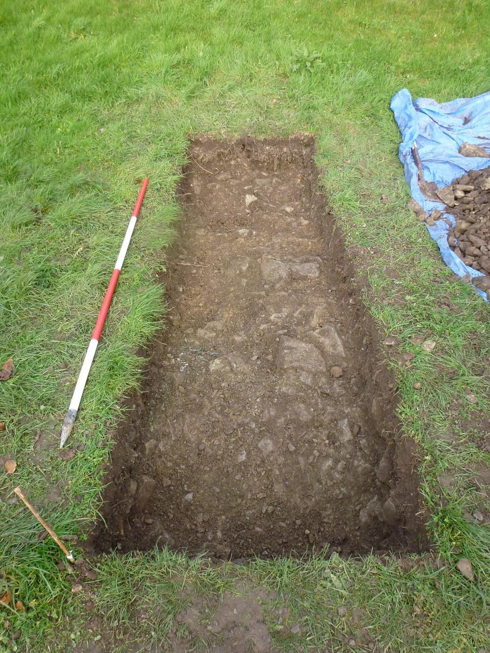 Figure 9: Trench 2B (Car Park Evaluation), following excavation of dumped-deposit of quarried stone (203) and the same deposit as a fill (204) of construction cut for the car park (206), exposing