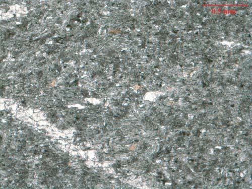 The grain size and mineralogy of these rocks also varies within the unit, with samples containing varying amounts of epidote, quartz, garnet, serpentine and plagioclase.