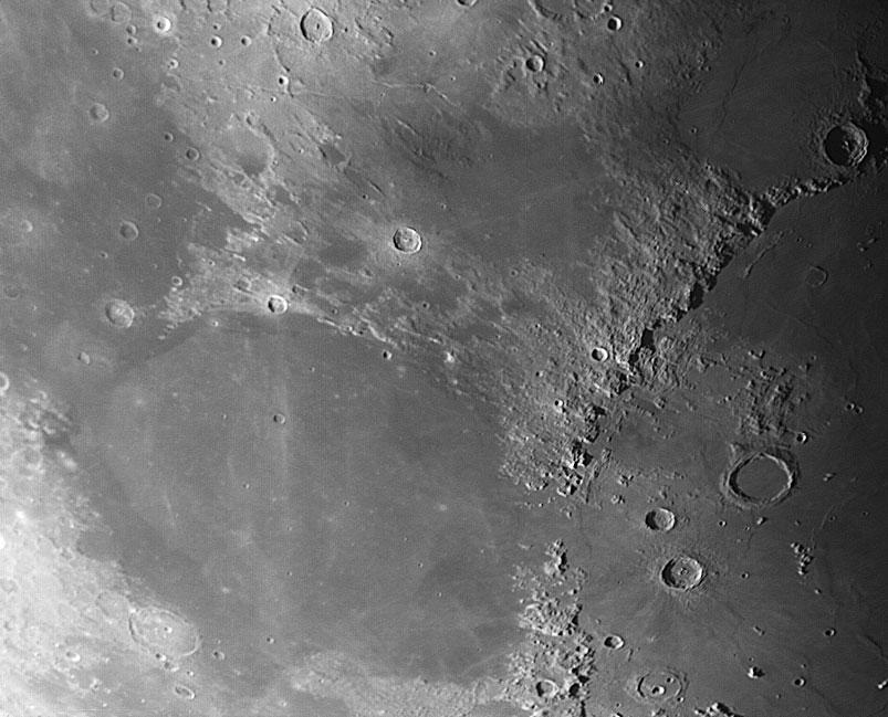 Figure 1: An image of the Moon depicting the lunar maria (the flat region) and lunar highlands (the rough mountainous regions). Impact Craters The Moon s surface is marked by impact craters.
