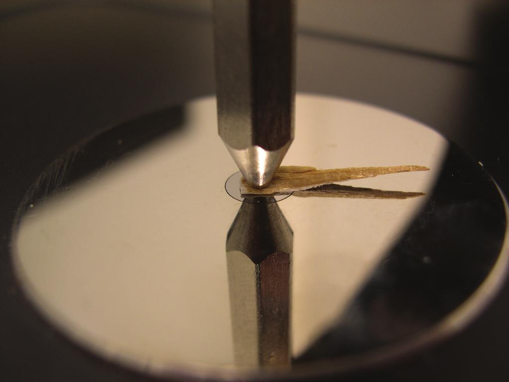 In the close-up photo to the right, the lower steel pin is only a reflection of the above steel pin in the polished mirror-like sample plate.
