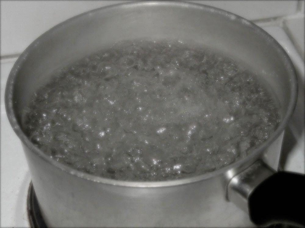 in boiling the stuff (solute) interferes with the water molecules ability to push out