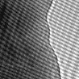 Off-axis electron hologram from thin crystal with enlargement showing interference fringes within sample.