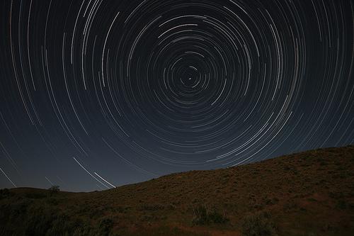 Time lapse photograph of Polaris and neighbouring stars As stated above, the stars all move in circles about Polaris, completing one orbit in just under 24 hours.