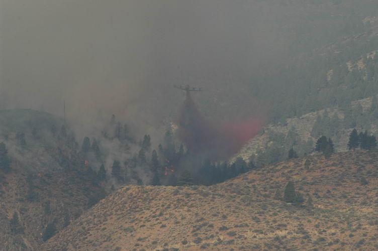 Big P3 tanker coming out of the smoke on a retardant dump.