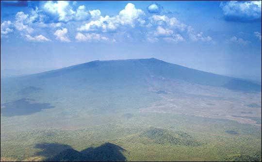 Nyamuragira Volcano: Geological Context Nyamuragira is a massive, intra-rift, basaltic shield volcano situated on the western