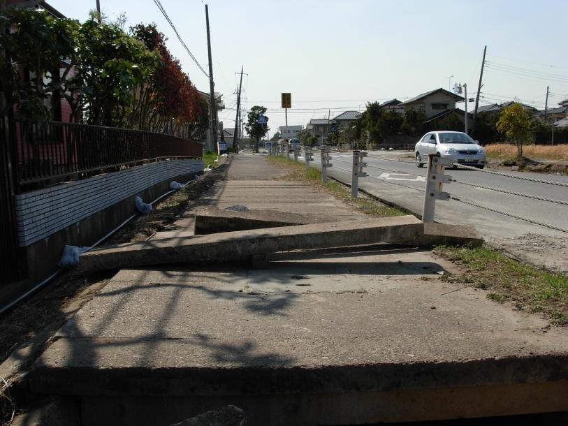11a) 11b) Photo 11a) and 11b). Distortion of the ground surface under the sidewalk.