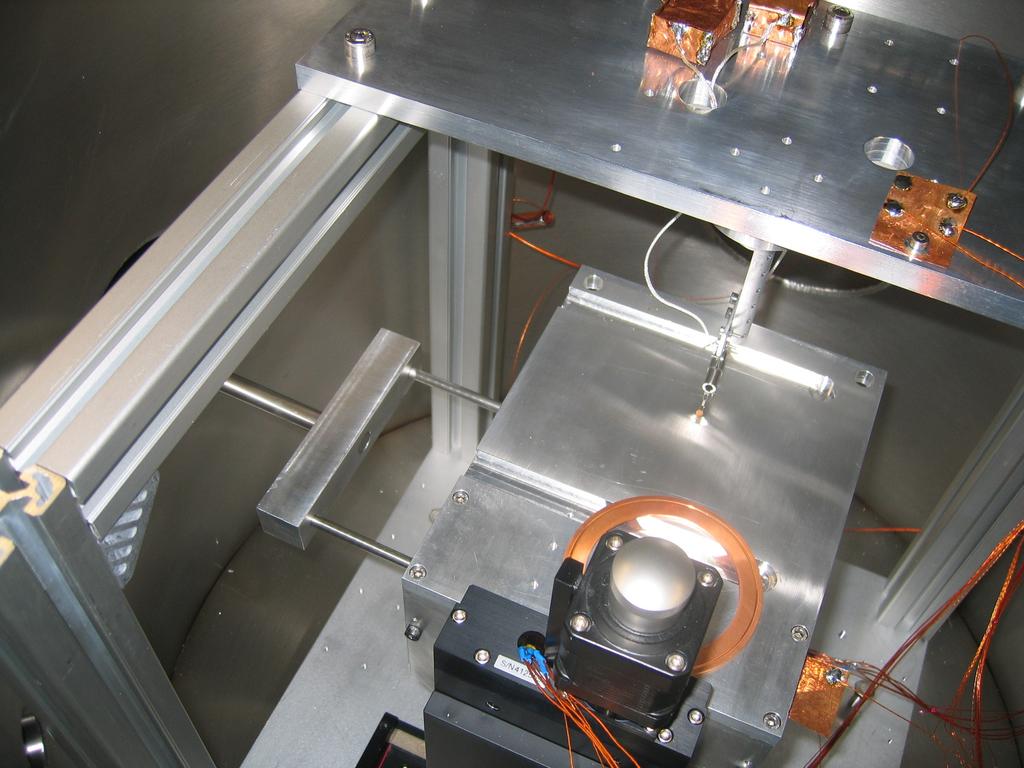 The sample loading rod is loaded through one and the other is used to connect a pump and valve so that the vacuum in the sample loading chamber can be changed without affecting the vacuum in the main