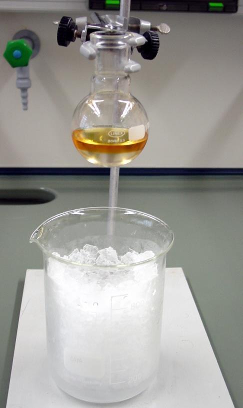 An ice bath and slow stirring are used because the hot acid causes the oxidation of NaBr to Br 2, useless in the experiment. The NaBr is dissolved during heating.
