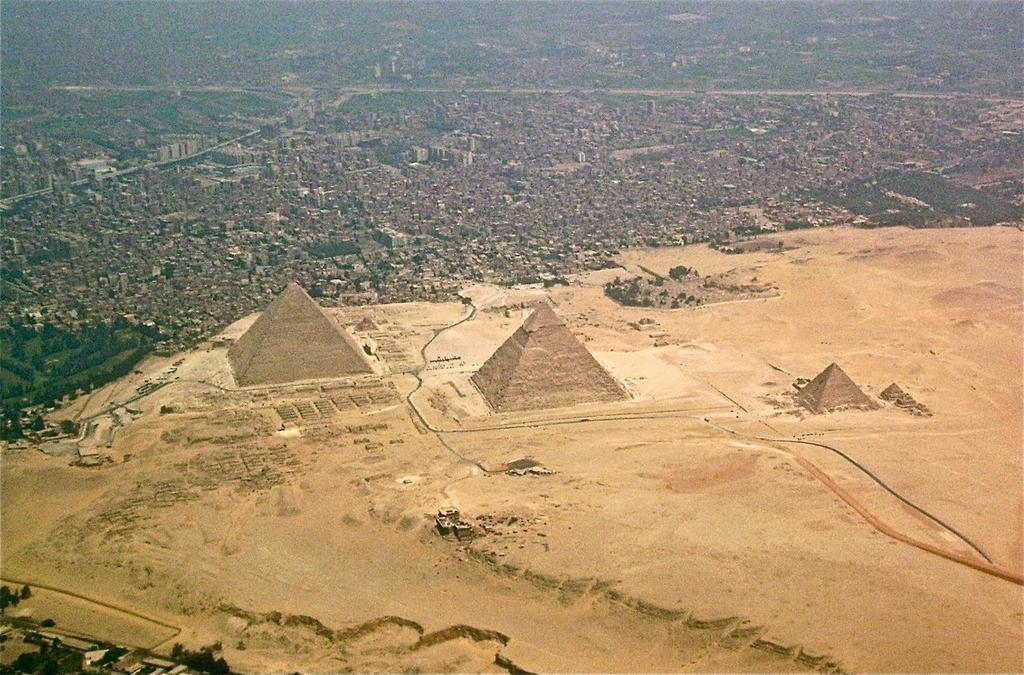 The three pyramids of Giza are located on the outskirts of Cairo, Egypt s capital. See how the pyramids overlook the city? All three pyramids were built for the same family.