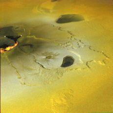 A zoomed in view (false color but shown as yellow because most of Io s surface is covered in sulfur) shows lava flowing from a volcano.
