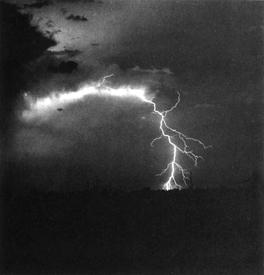 Figure 18.3: Lightning over the Arizona desert. (Courtesy, J. Rodney Hastings, University of Arizona) The earth is recharged by thunderstorms. Fig. 18.1 shows how the electrical balance of the atmosphere is maintained.