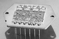 On the right from top to bottom, a LM324 DIP (dual in-line pack), LMC6294 DIP, and MAX424 in a SO-5 package (small outline/5 pins). A penny is shown for purposes of comparison.