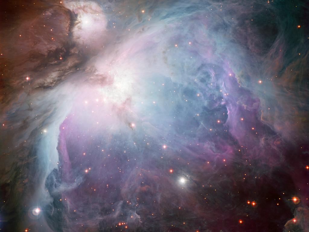 The Orion Nebula (top) is a star forming region visible to the unaided eye. The bottom figure shows a spectrum of the gas between the stars there.