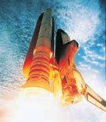 Figure 7 In this view of the shuttle, a redcolored external liquid fuel tank is behind a white, solid rocket booster.