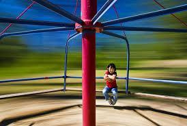 A playground merry-go-round of radius R = 2.