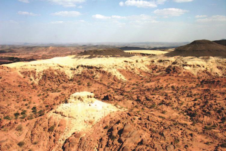 122 Saudi Arabia: An Environmental Overview Figure 6.4 Harrat as Sarat lava overlying mid-tertiary saprolites blanketing Precambrian basement (Photo: author). final amalgamation around 550 Ma.