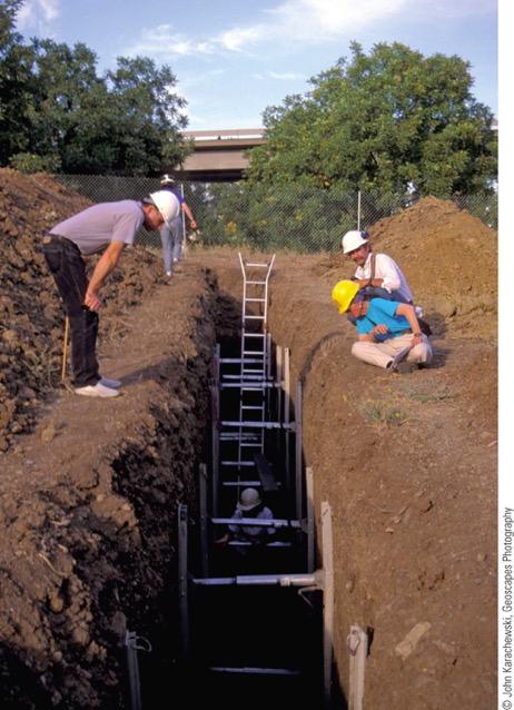 Geologists examine a trench across an active fault in California to determine possible seismic hazards.