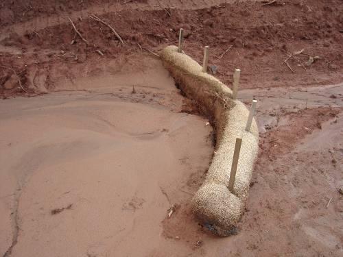 Sediment Tube Ditch Check Description: 82 Sediment tubes are elongated tubes of compacted geotextiles, curled excelsior wood, natural coconut fiber or