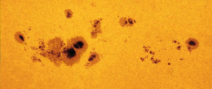 FIGURE 15.13 Sunspots. This image of sunspots, cooler and thus darker regions on the Sun, was taken in July 2012.