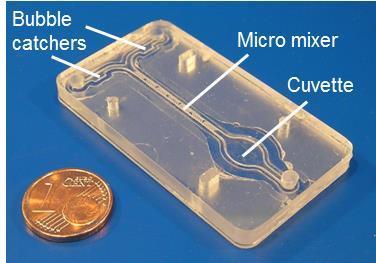 A polymer chip from polycarbonate (PC) with bubble catching cavities, a herring bone micro mixer, and a cuvette for optical measurements has been fabricted by ultrasonic processing (cf. Fig. 2).