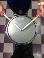 Approach to the drum should be straight up and down, making sure not to slice out in either direction. Place L.H. stick in-between thumb and forefinger.